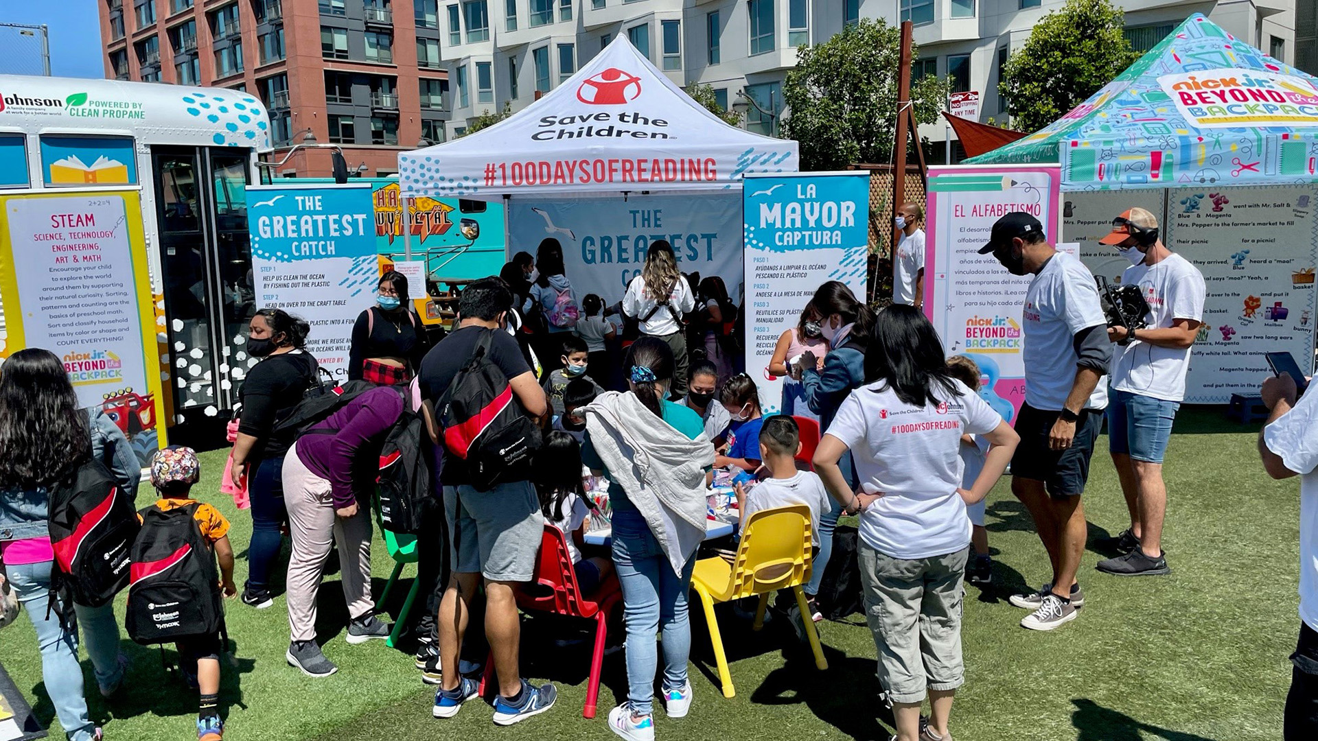 Save the Children and 100 Days of reading tent outside with children